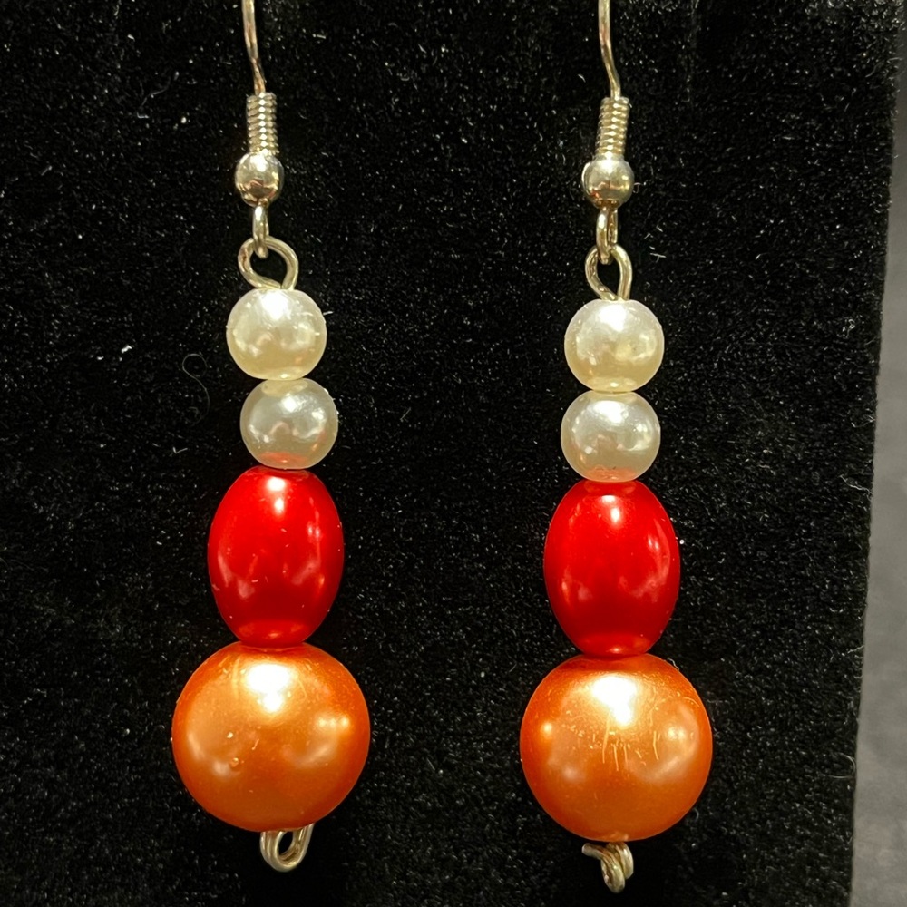 Vibrant orange, white and coral colored Handcrafted bead dangle earrings.